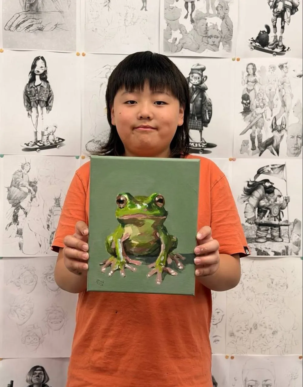 Young student presenting their artwork