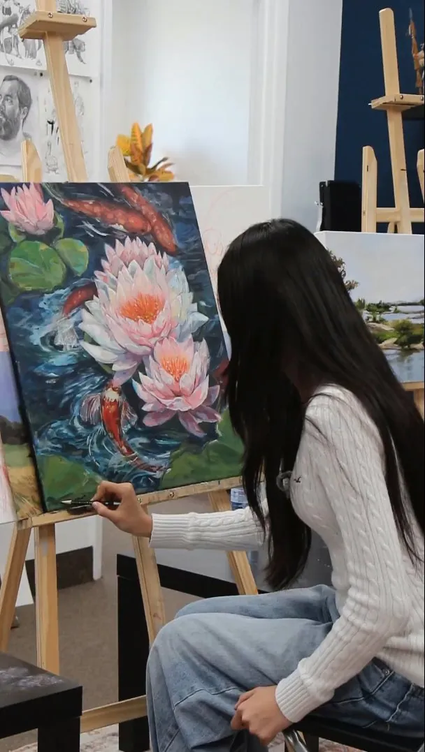 Painting of lotus blossoms and koi in a pond